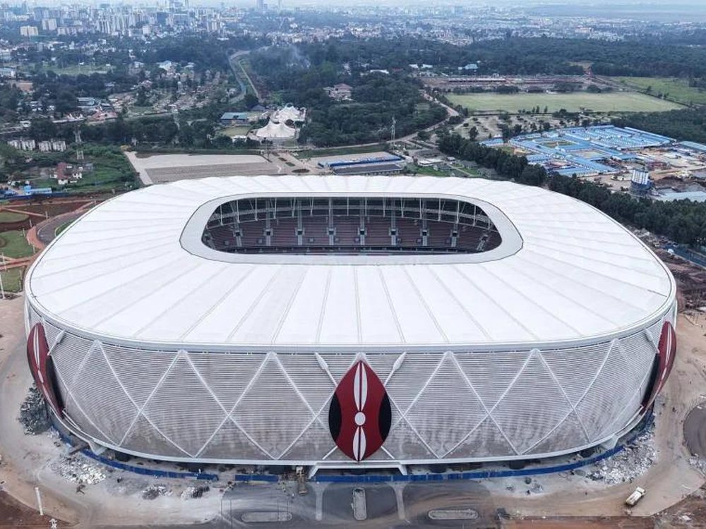 Aerial view of the white, oval Raila Odinga International Stadium with a red Maasai shield design on its side