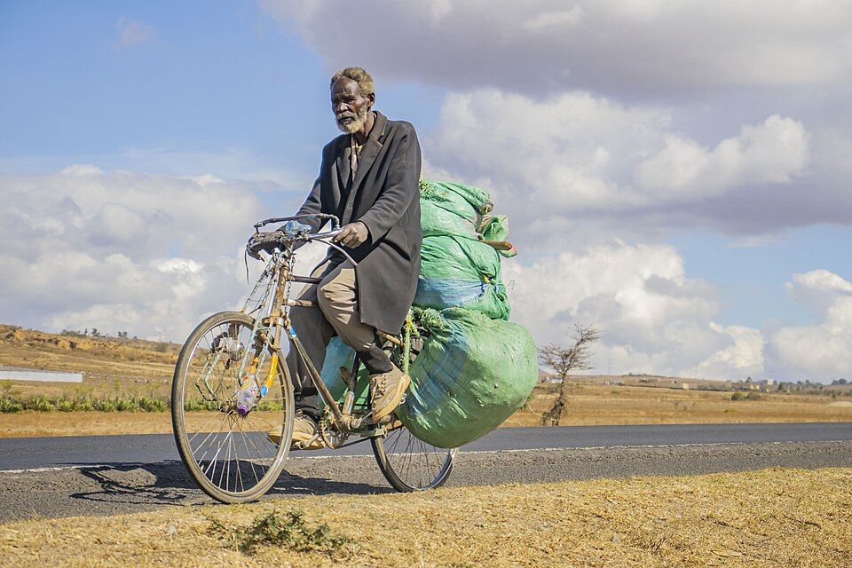 A man rides a bicycle along the Nairobi-Nakuru highway
