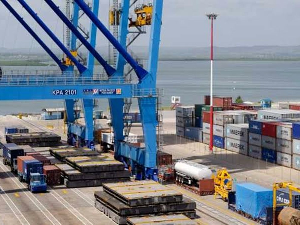 A ship-to-shore crane marked KPA 2101 beside stacked containers at the Port of Mombasa