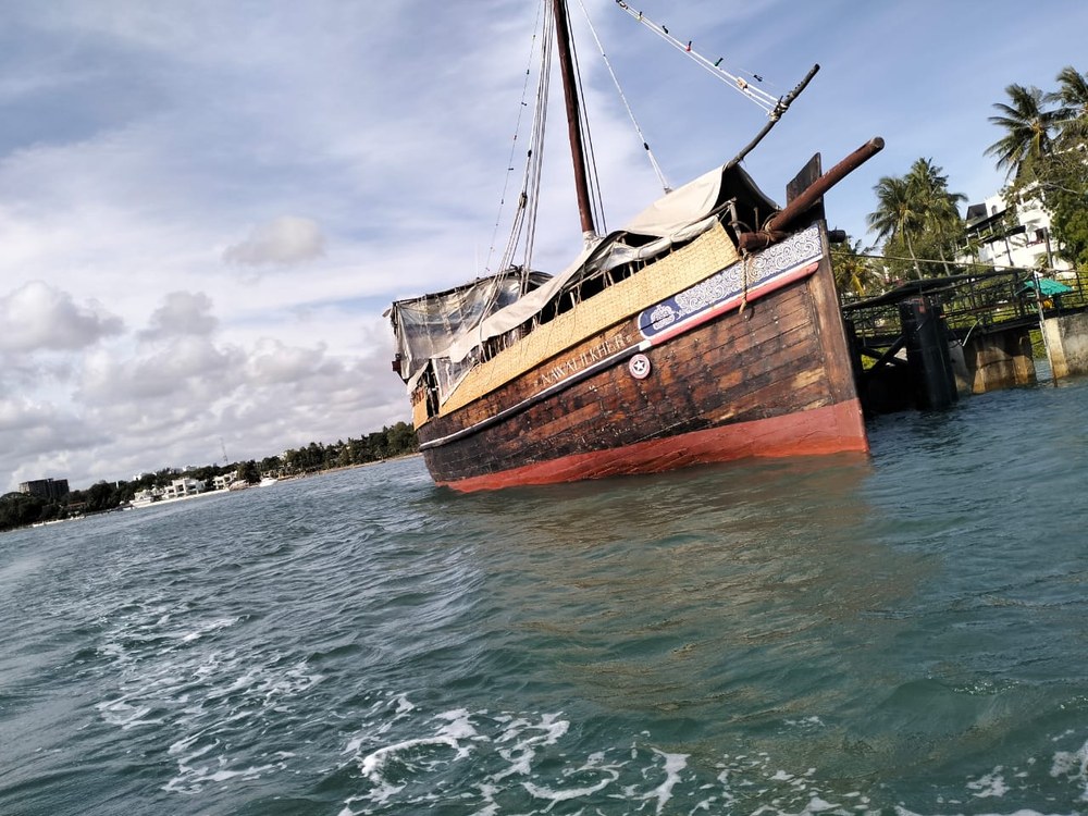 A wooden dhow moored in choppy water in Mombasa