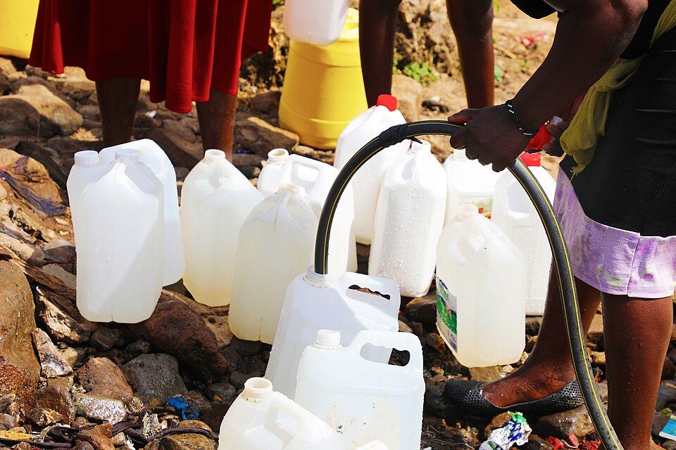Water cans being filled from a hose in Nairobi