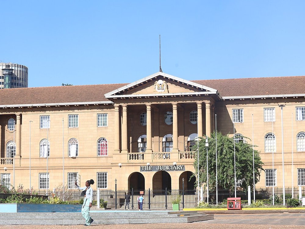 The Judiciary building in Nairobi, a sandstone building with columns and a sign reading The Judiciary